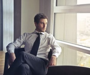 A person sitting in quiet reflection, representing true character and inner strength.