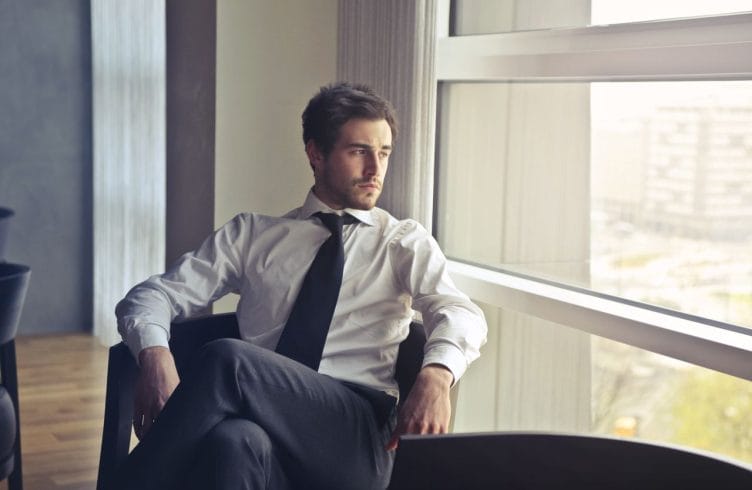 A person sitting in quiet reflection, representing true character and inner strength.